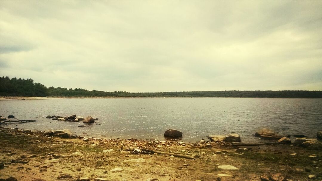 water, sky, tranquility, tranquil scene, scenics, beauty in nature, cloud - sky, nature, lake, rock - object, cloudy, lakeshore, idyllic, cloud, non-urban scene, river, shore, stone - object, outdoors, no people