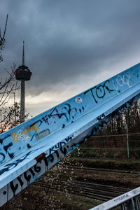 Information sign on bridge against sky