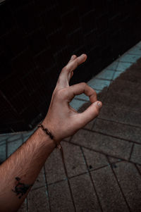 High angle view of man hand on footpath