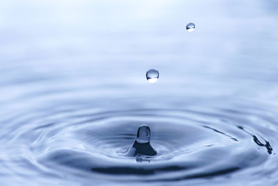 Close-up of water splashing in sea against sky