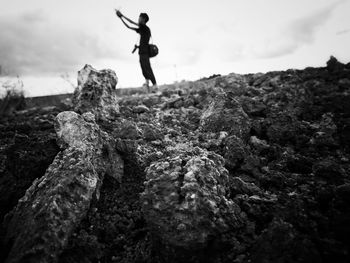 Low angle view of man standing on rock formation