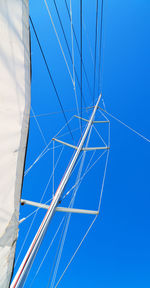 Low angle view of cables against blue sky