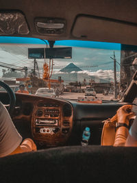 Midsection of man seen through car window