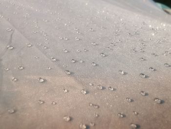 Full frame shot of raindrops on sand