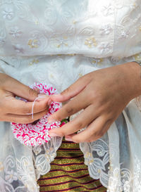Midsection of couple holding hands