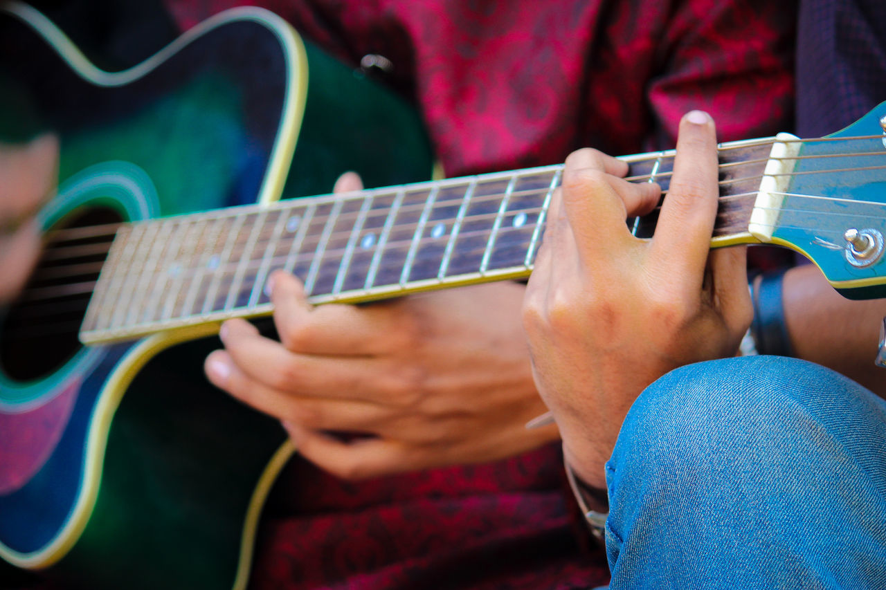 musical instrument, music, string instrument, human hand, real people, hand, playing, musical equipment, guitar, arts culture and entertainment, midsection, one person, lifestyles, holding, human body part, men, musical instrument string, artist, string, musician, skill, body part, plucking an instrument, finger