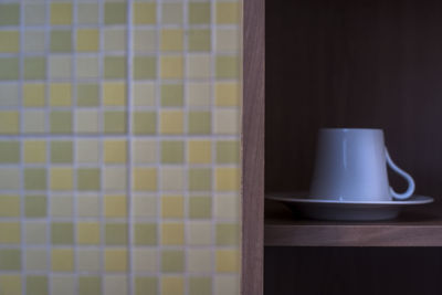 Close-up of coffee cup on table at home