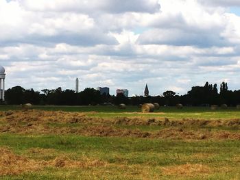 Scenic view of field against cloudy sky