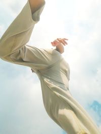 Low angle view of human walking against sky. 