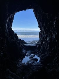 Scenic view of sea seen through cave