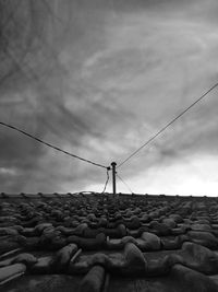 Low angle view of man standing on rock against sky