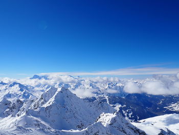 Scenic view of snow covered mountains against sky