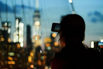 Rear view of person photographing in city