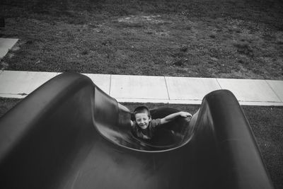 High angle view boy playing at slide