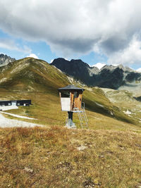 Scenic view of field and mountains against sky