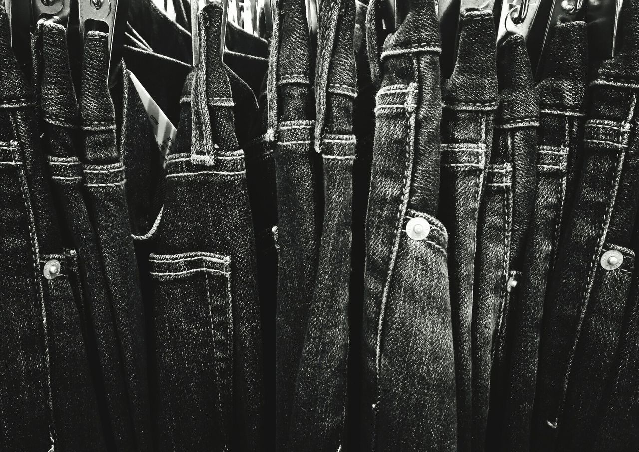 side by side, no people, full frame, close-up, backgrounds, large group of objects, in a row, day, abundance, hanging, arrangement, variation, choice, clothing, repetition, indoors, order, sunlight, pattern