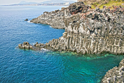 High angle view of sea by rock formations