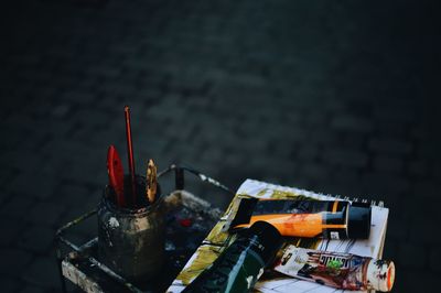 High angle view of paint tubes on table