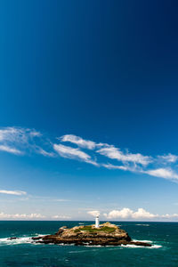 Scenic view of sea against blue sky