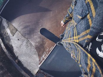 Low section of man with skateboard on ramp