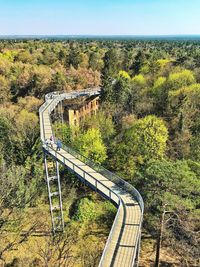 Railroad tracks by trees on landscape against sky