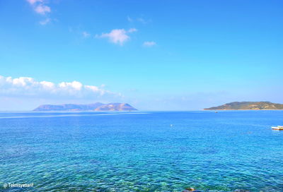 Scenic view of sea against blue sky