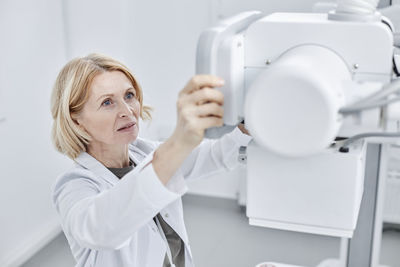 Doctor looking at x-ray machine in clinic