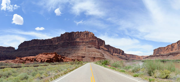 Road amidst landscape against sky