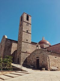 Low angle view of historical building against clear blue sky