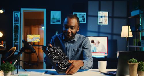 Portrait of young man using laptop while sitting at home