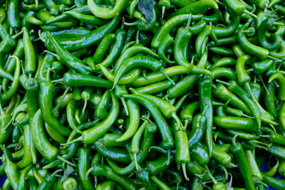 Full frame shot of green chili peppers for sale in market