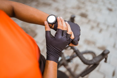 Midsection of cyclist checking time outdoors