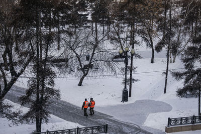 People skiing on snow covered land