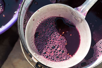 The winemaker pours grape juice for transportation into barrels.