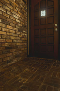 Illuminated lamp on wall of building
