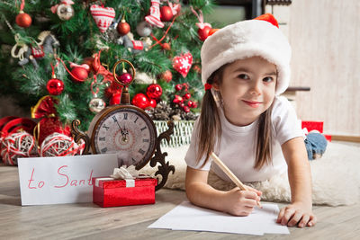 Portrait of smiling girl on table