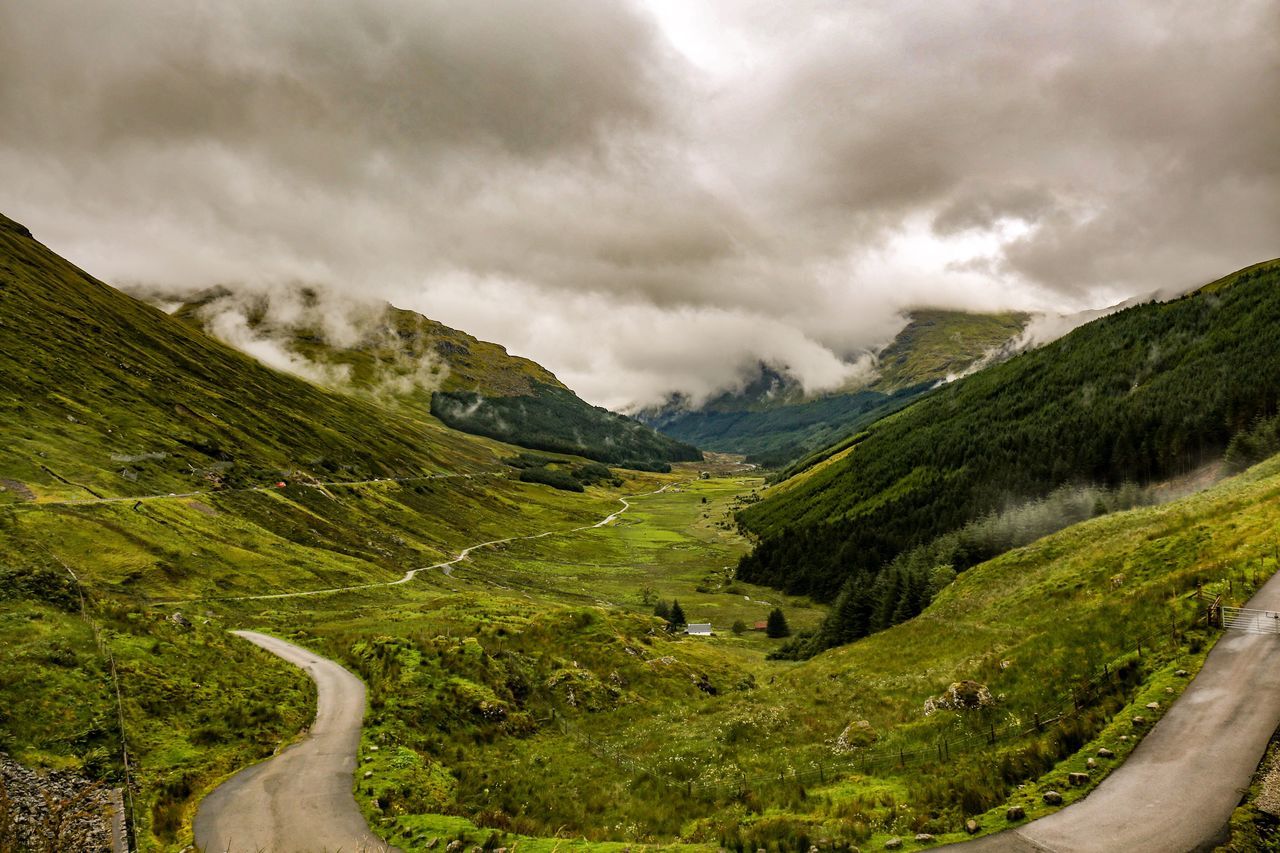 cloud - sky, sky, mountain, landscape, scenics, nature, beauty in nature, day, road, outdoors, winding road, no people, tranquil scene, tranquility, curve, grass, mountain road