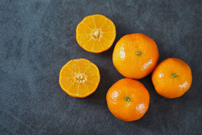 High angle view of orange fruits on black background