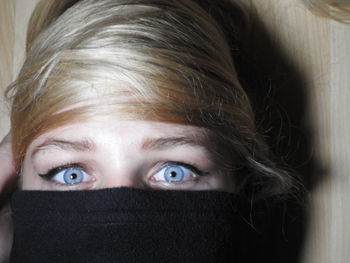 Close-up portrait of girl with blanket over face