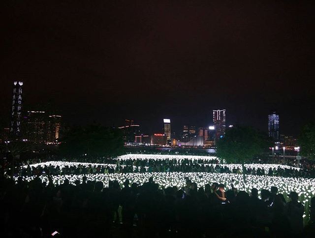 night, illuminated, copy space, clear sky, built structure, building exterior, architecture, arts culture and entertainment, crowd, dark, city, large group of people, lighting equipment, sky, outdoors, tree, event, celebration, light - natural phenomenon