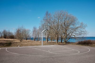 View of basketball hoop against blue sky