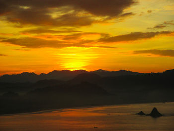 Scenic view of silhouette mountains against sky during sunset