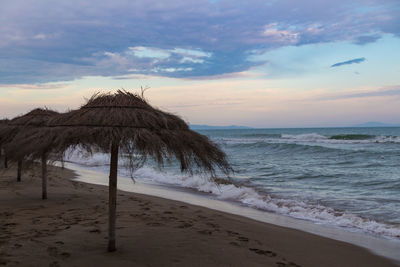Scenic view of beach against sky during sunset