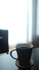 Close-up of coffee cup on table