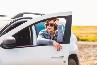 Portrait of young woman in car