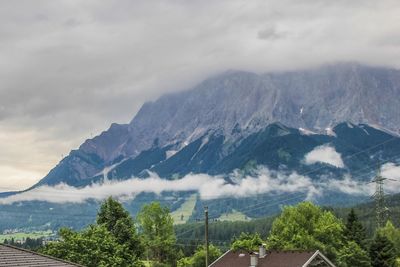 Scenic view of mountains against cloudy sky