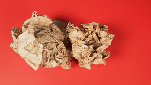 High angle view of paper on red background