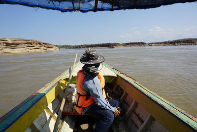 Man sitting on boat in sea