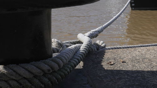 High angle view of rope tied to bollard