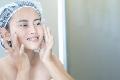 Portrait of smiling young woman in bathroom